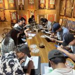 A group of international students are learning to hand-paint thangka